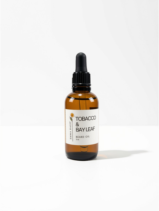 A 10ml amber glass dropper bottle of Earth Daily Tobacco & Bay Leaf Beard Oil, featuring a white label and black dropper cap, set against a clean white background.